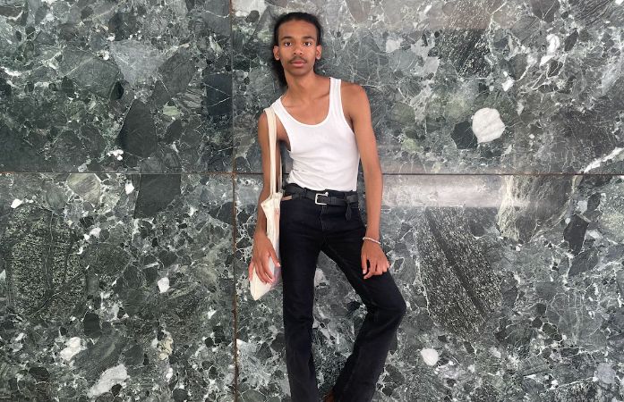  Student leaning against wall